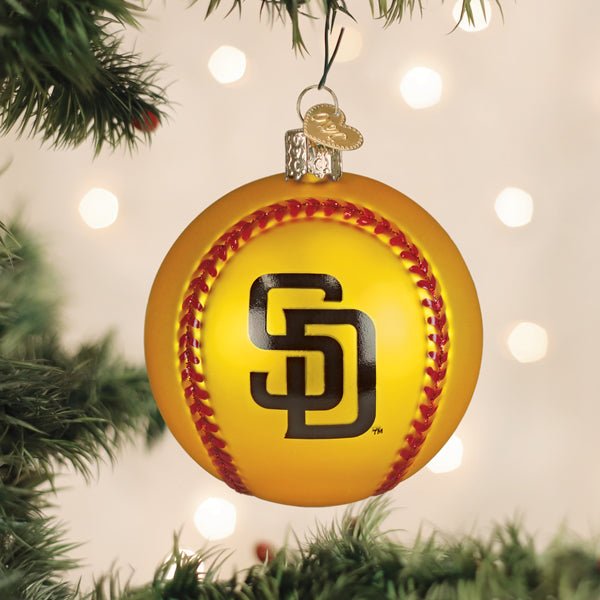 San Diego Padres baseball ornament hanging on a lit Christmas tree with warm bokeh lights and pine branches
