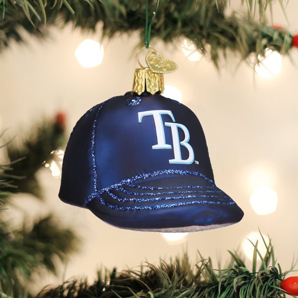 Rays cap ornament hanging on a lit Christmas tree with warm glowing bokeh lights behind