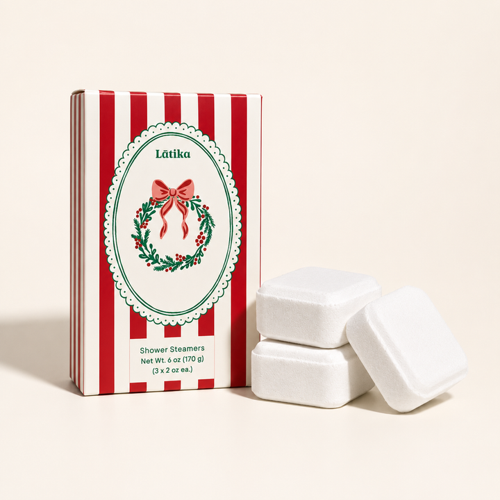 Red striped Latika box with wreath crest and three white shower steamers, a pine and cedarwood stocking stuffer