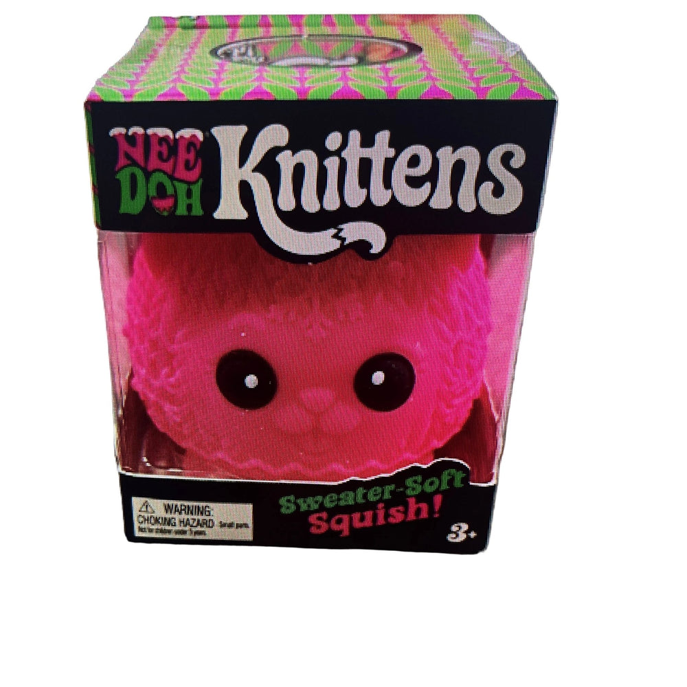 A pink fuzzy Nee Doh Knittens 'Sweater Soft Squishy' toy in its original retail packaging, sitting on a mottled gray countertop.