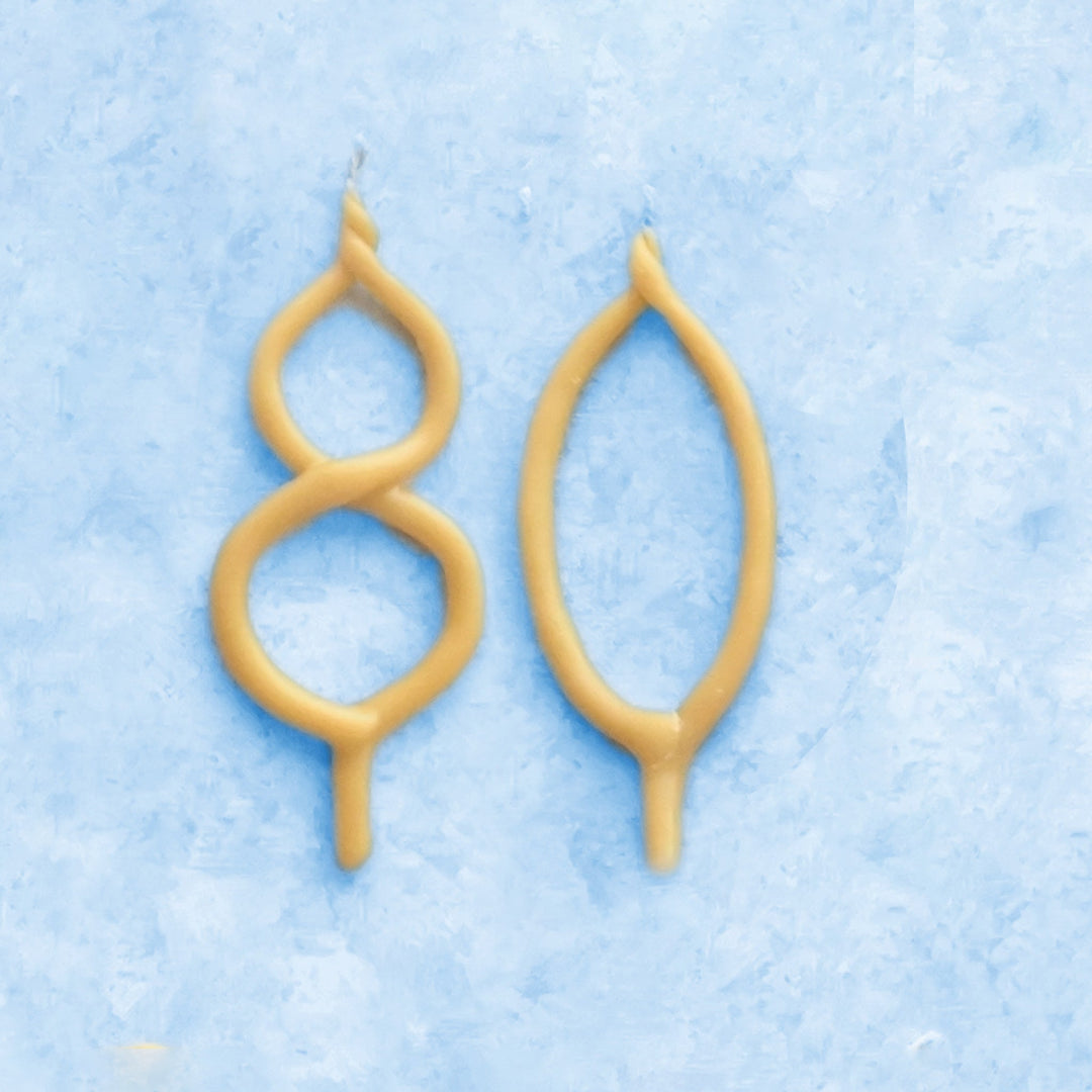 Beeswax number 80 birthday candles in natural honey color for an 80th birthday celebration