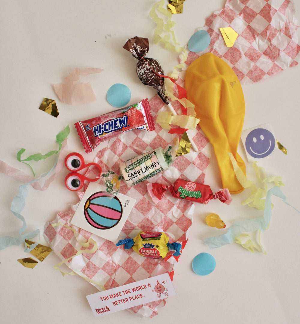 Checkered bon bon goodies: Hi-Chew, yellow balloon, googly eyes, beach ball tattoo, and confetti for goodie bags
