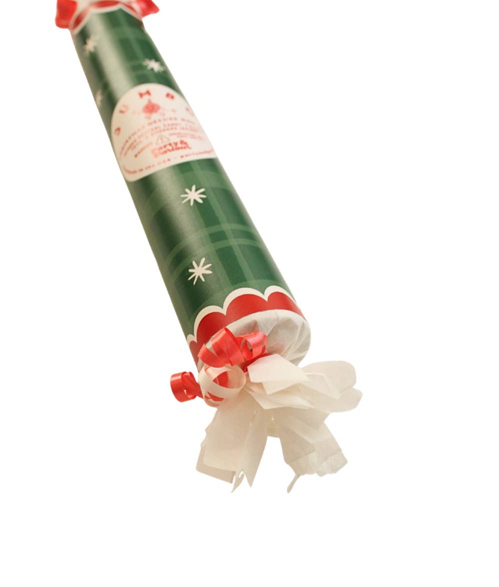 Angled close-up of the green plaid bon bon's star print, red scallop band, and curled ribbon end, a holiday favor