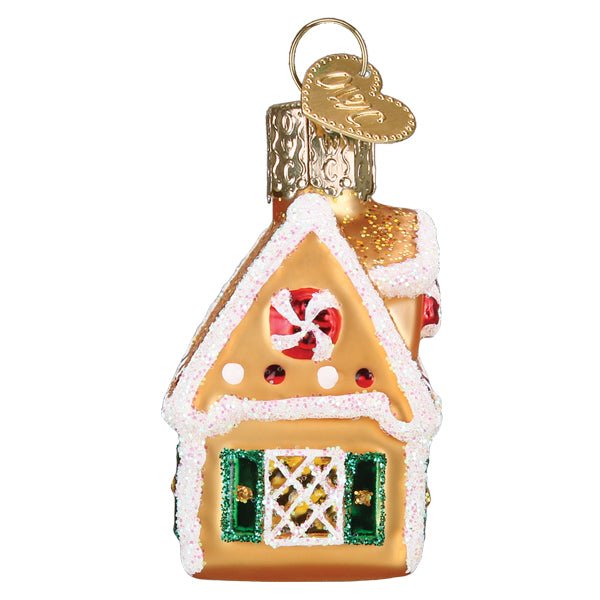 Gable end of the gingerbread house ornament showing its peppermint swirl and candy dots, on white