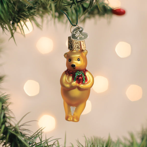 Mini Winnie the Pooh glass ornament holding a gift for a Christmas tree