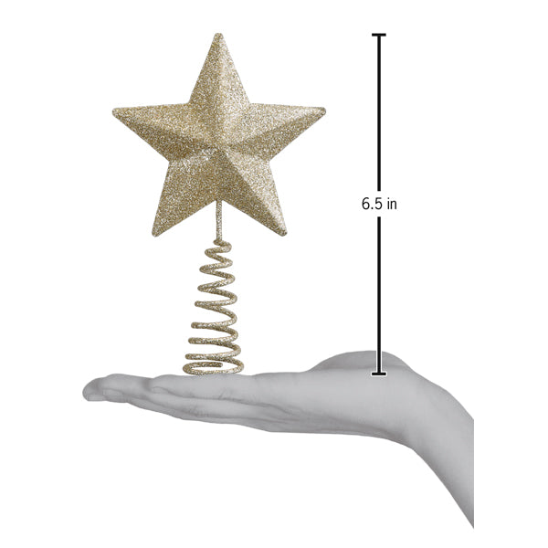 Mini star tree topper on an open palm beside a 6.5 inch height marker