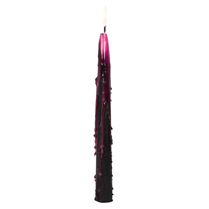 Single black taper streaked with dripping magenta wax, a moody accent for a Halloween dinner table