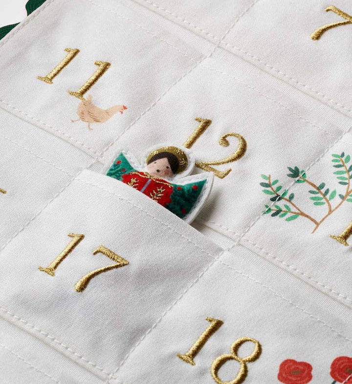 Angel figurine tucked in a numbered pocket of the nativity advent calendar, moving day by day to Christmas