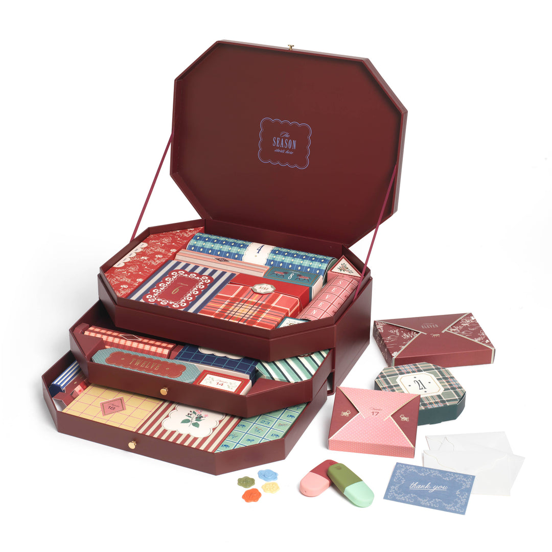 Papier 2026 stationery advent calendar open to show burgundy keepsake drawers of numbered gifts for Christmas countdowns