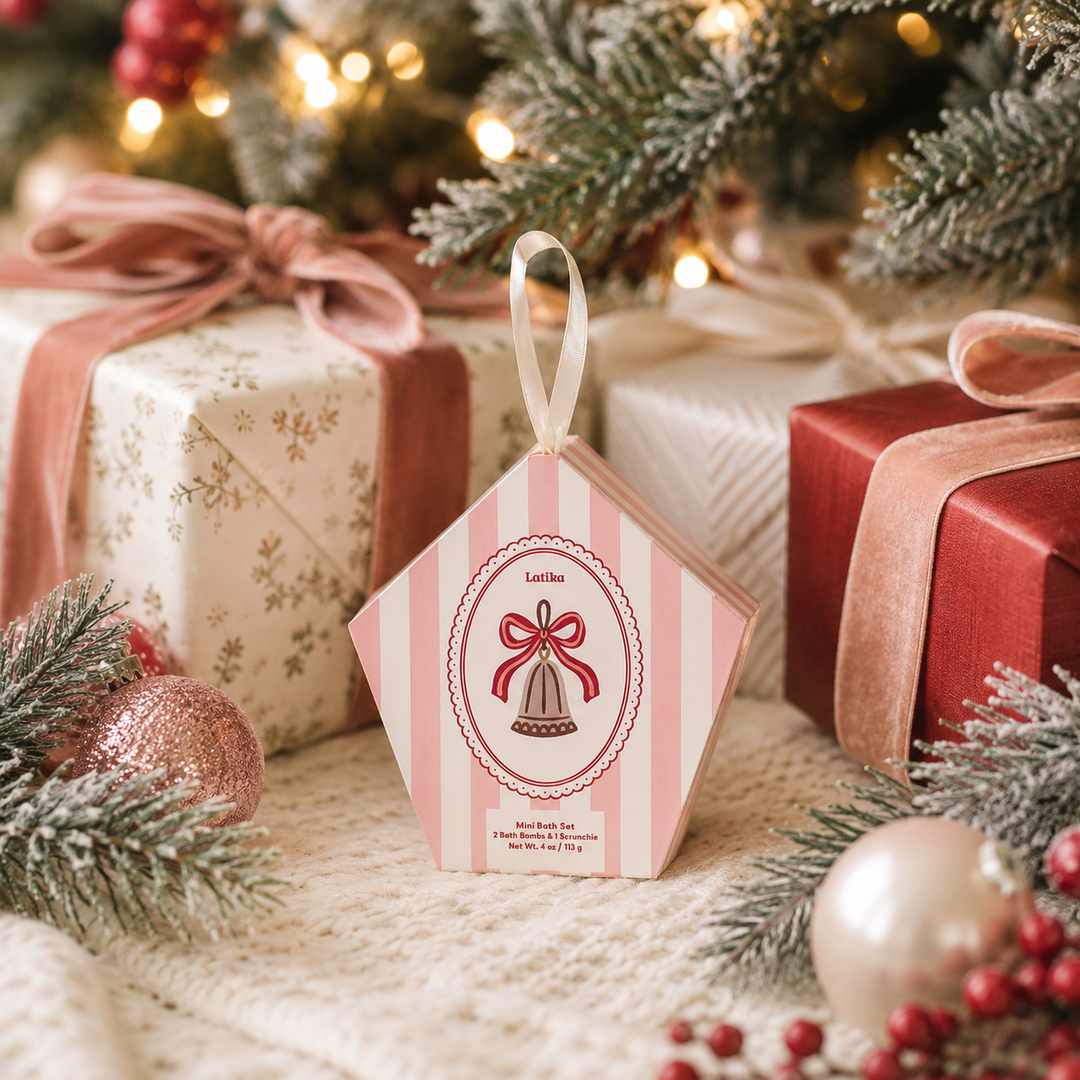 Bell bath set box tucked under the tree with velvet-ribboned gifts, a sweet Christmas gift topper
