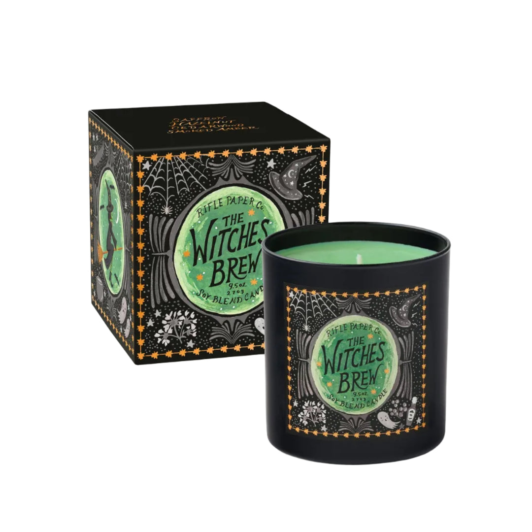 Witches Brew Halloween candle with green wax in black illustrated vessel beside its starry black gift box