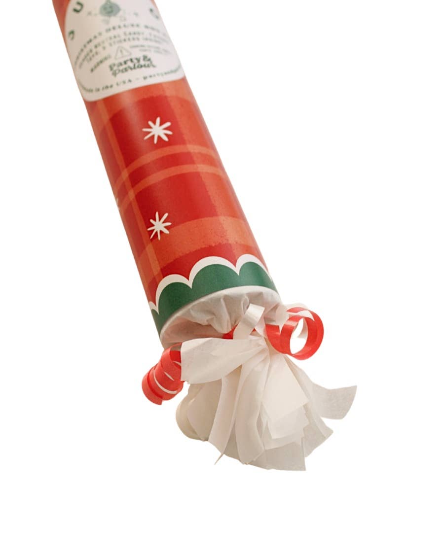 Angled close-up of the red plaid bon bon's star print, green scallop band, and curled ribbon end, a holiday favor