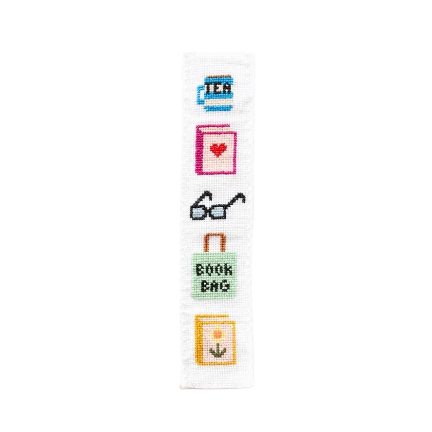 Bookish cross stitch bookmark with tea mug, heart book, glasses, and book bag motifs
