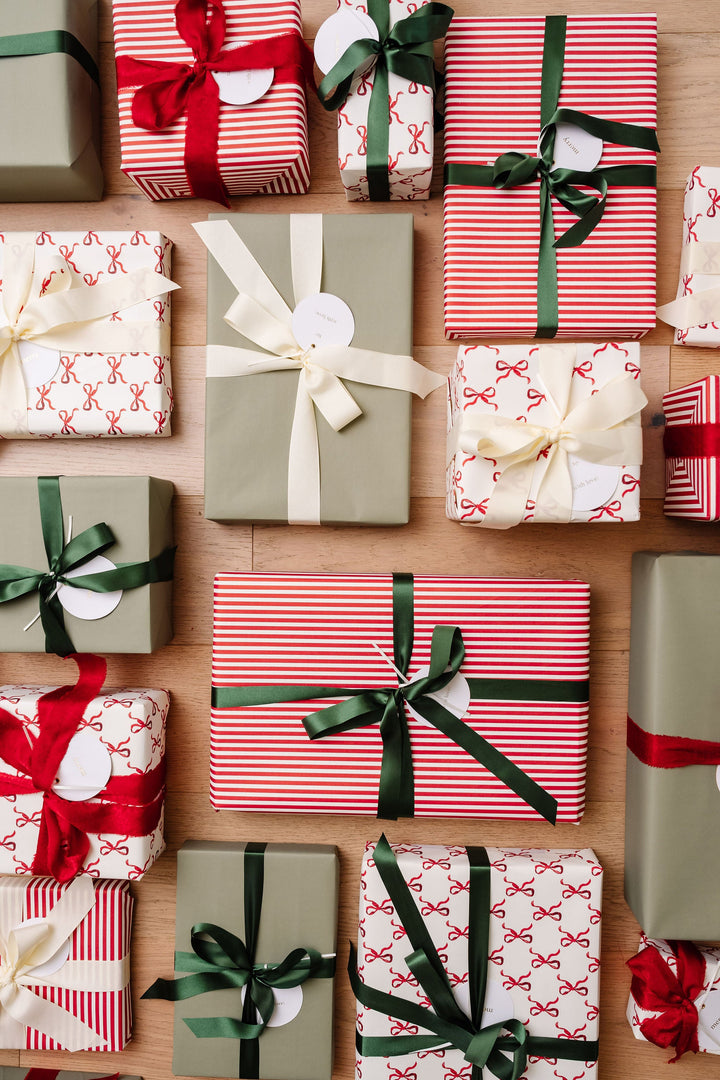 Overhead rows of striped, bow print, and green gifts finished with round letterpress tags