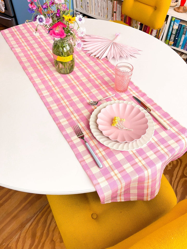 Bubblegum and peach plaid table setting for a baby shower or birthday
