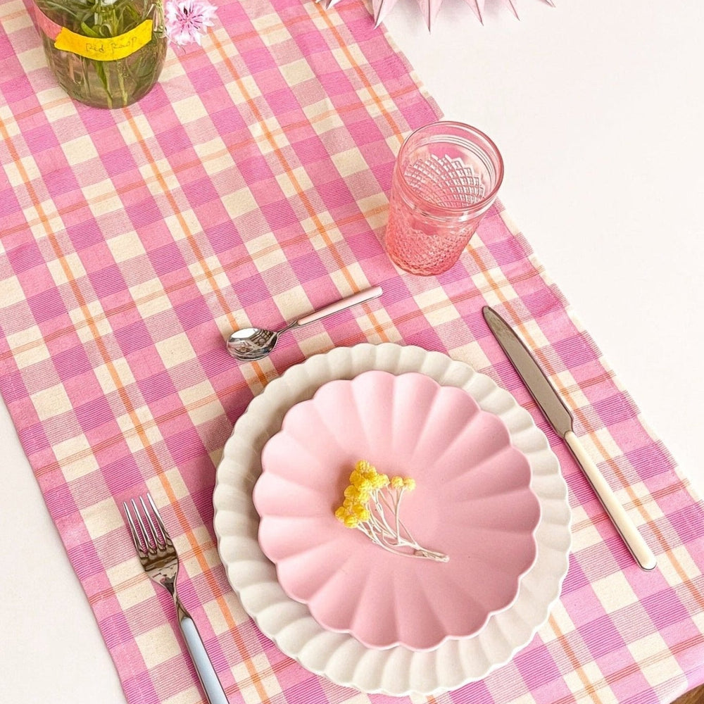 Bubblegum and peach plaid table runner styled on a tabletop for a spring gathering