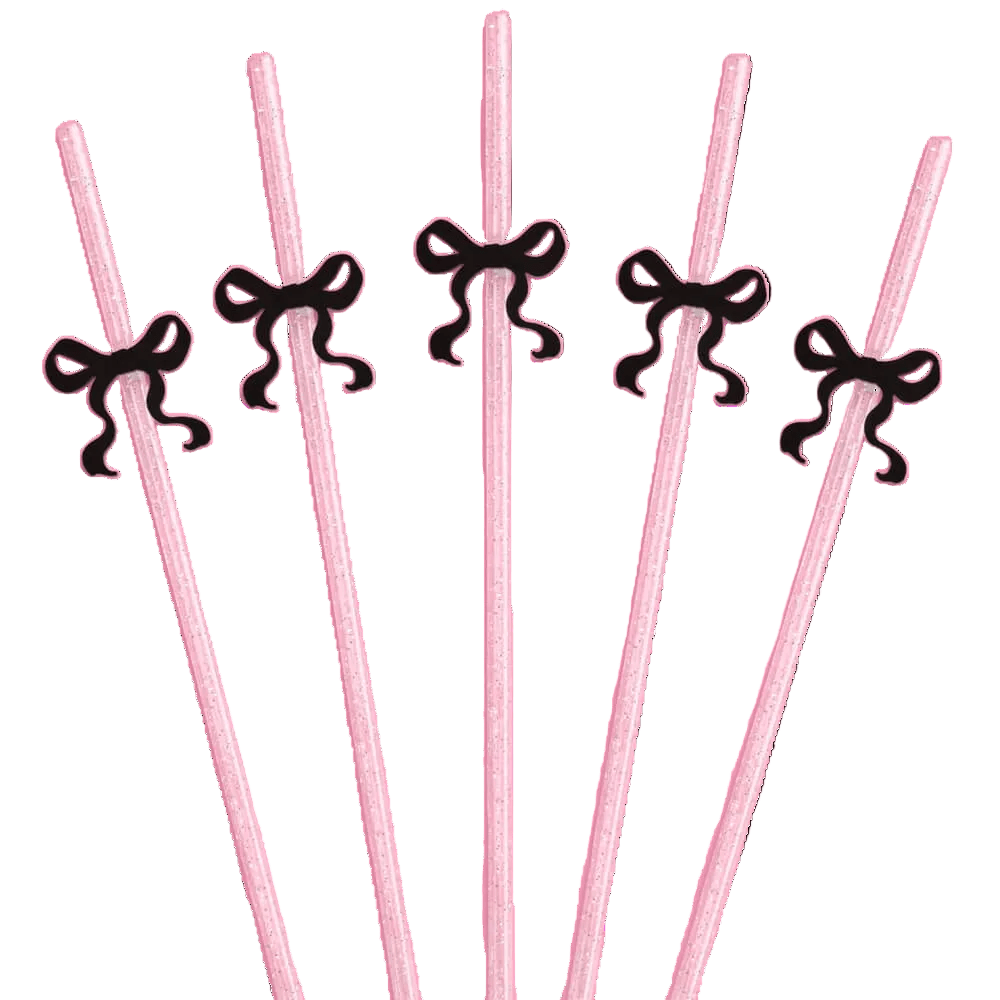 Pink glitter reusable party straws each topped with a black bow charm for a coquette themed celebration