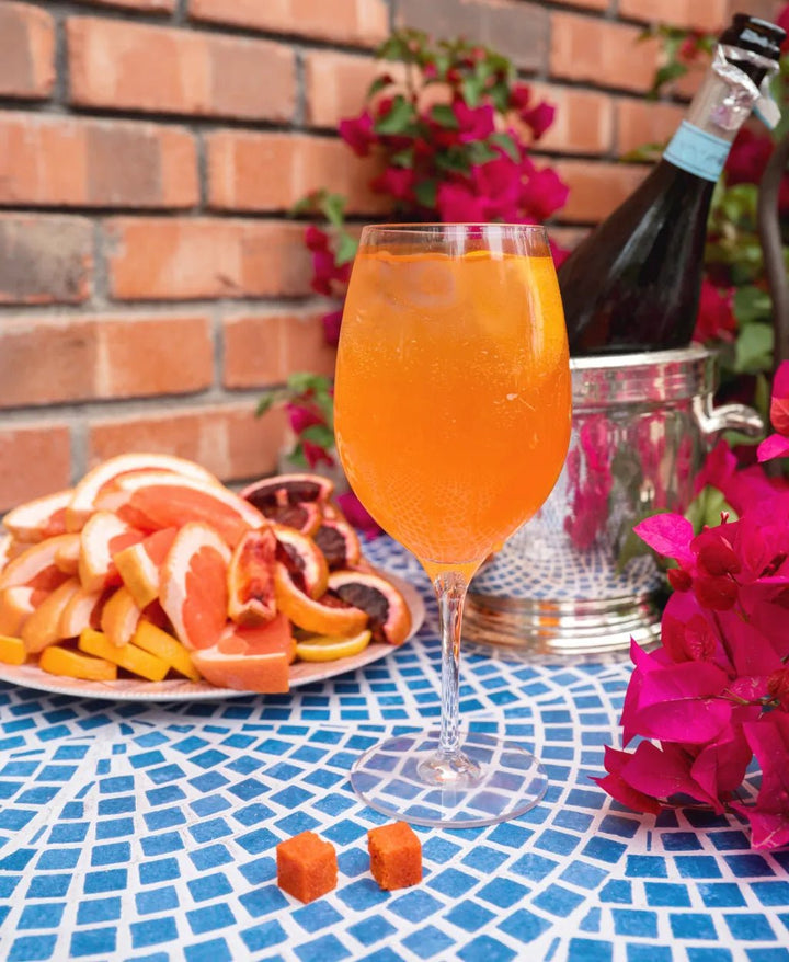 Aperitivo spritz mixer cube dropped into a glass of prosecco