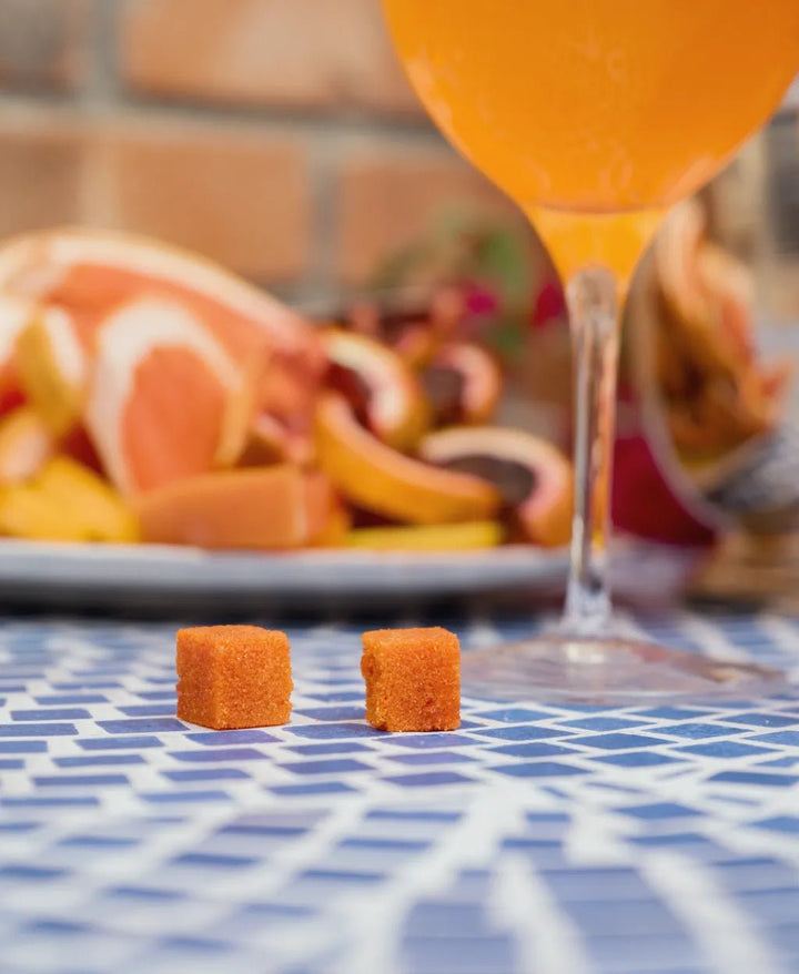 Orange aperitivo spritz in a wine glass with an orange slice on a patio table