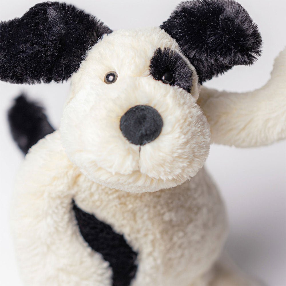Jellycat Bashful Black and Cream Puppy plush, a cuddly stuffed animal gift for a birthday or baby shower.