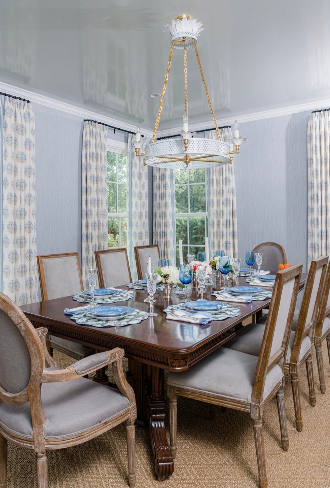 Frances Fields Home holiday placemat, round with a scalloped edge, in a blue Christmas wreath design