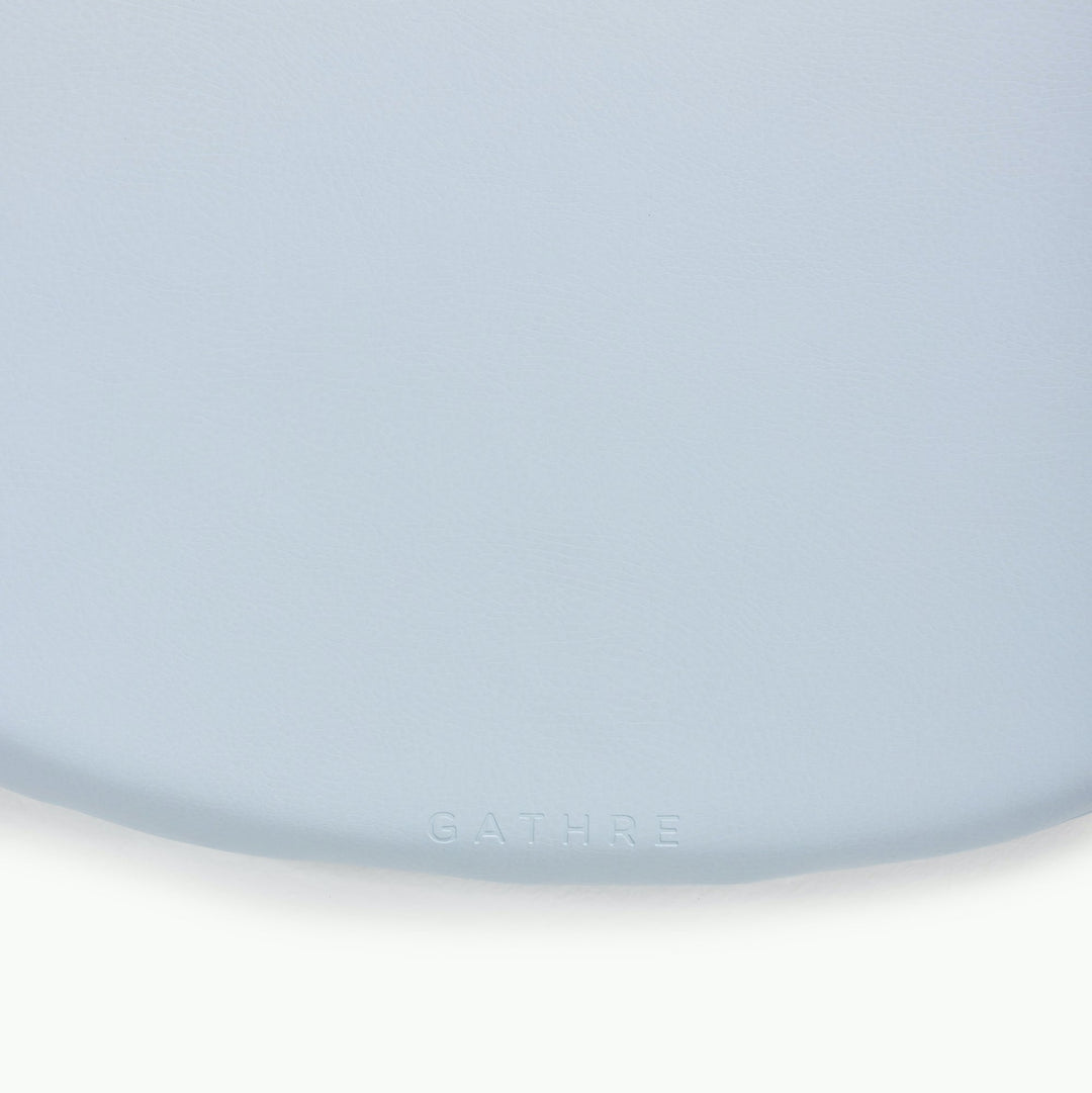 Light blue round padded play mat, close-up of the soft wipeable surface.