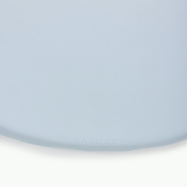 Light blue round padded play mat, close-up of the soft wipeable surface.