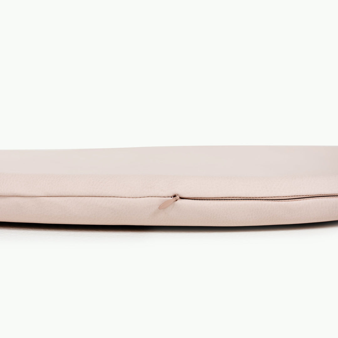 Cream blush round padded play mat side view showing the cushioned zippered edge.
