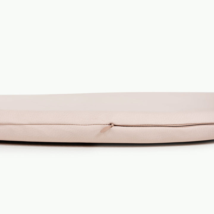 Cream blush round padded play mat side view showing the cushioned zippered edge.