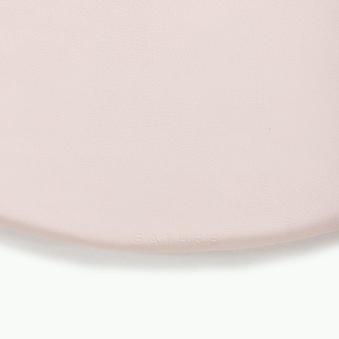 Cream blush round padded play mat, close-up of the soft wipeable surface.