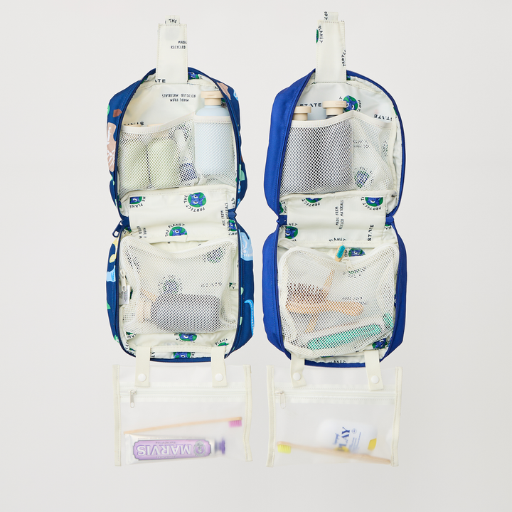 Two opened Bensen toiletry bags packed with toiletries, Dino Fossils on the left and Mountains on the right