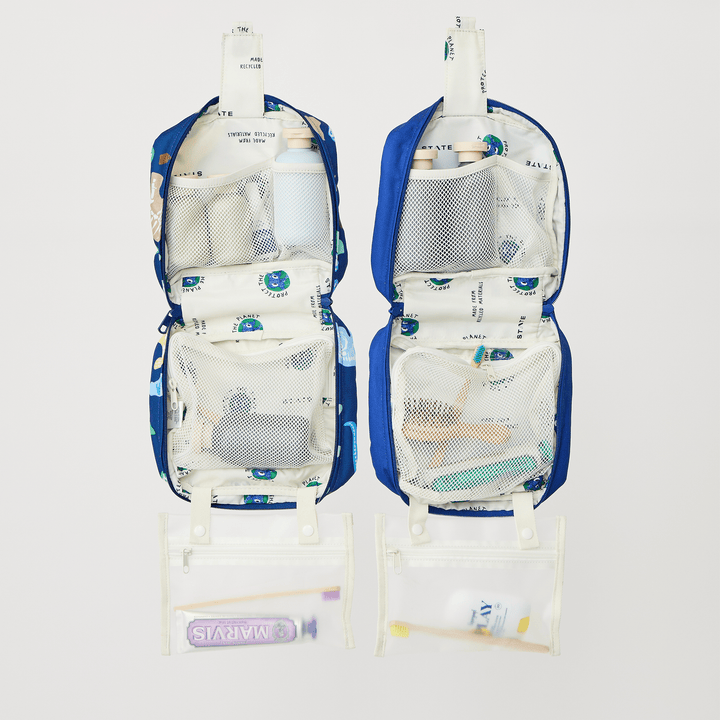 Two opened Bensen toiletry bags in other prints packed with toiletries to show storage