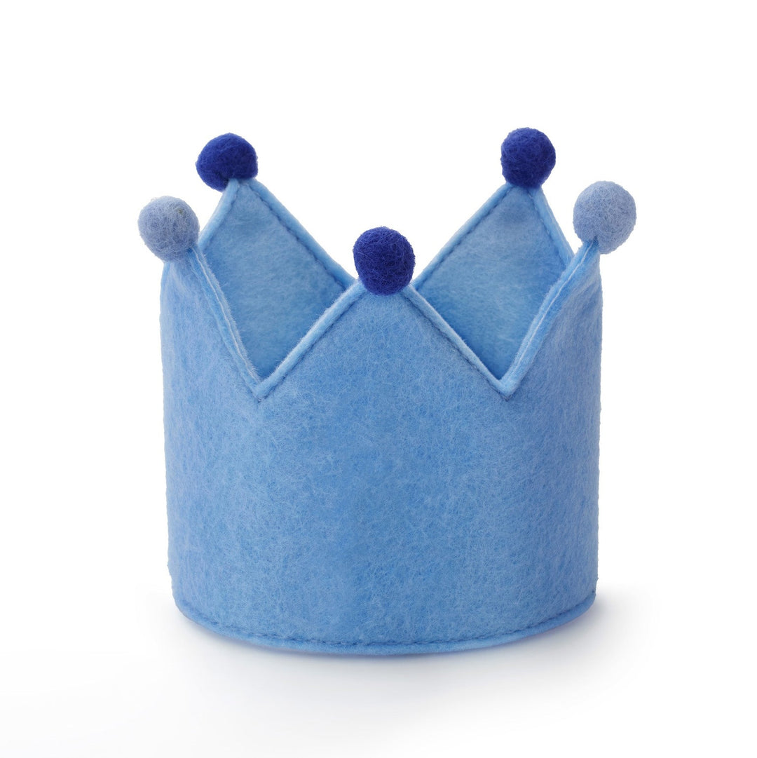Light blue felt dog birthday crown with navy and periwinkle pom-poms, front view on white