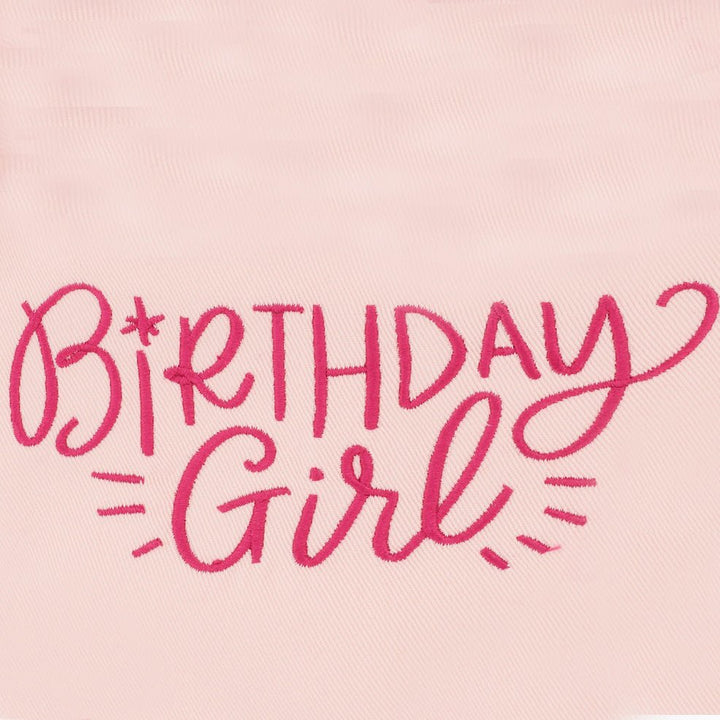 Close-up of hot pink Birthday Girl script embroidery on pale pink bandana fabric