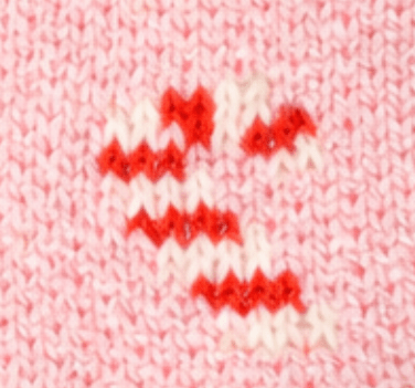 Close-up of the sweater-knit texture, candy canes on blush pink