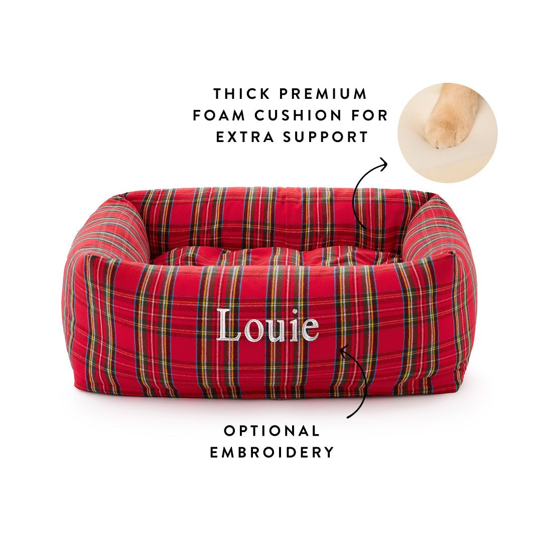 Red tartan bolster bed embroidered Louie with callouts for the foam cushion and optional embroidery