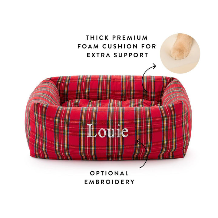 Red tartan bolster bed embroidered Louie with callouts for the foam cushion and optional embroidery