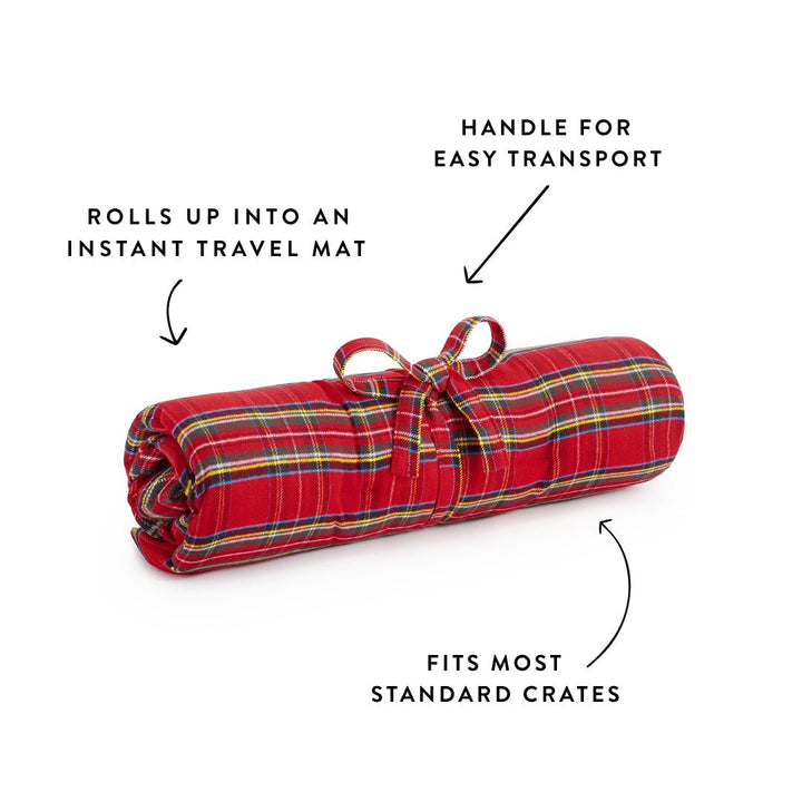 Quilted tartan topper rolled and tied as a travel mat with a carry handle, crate pad callout