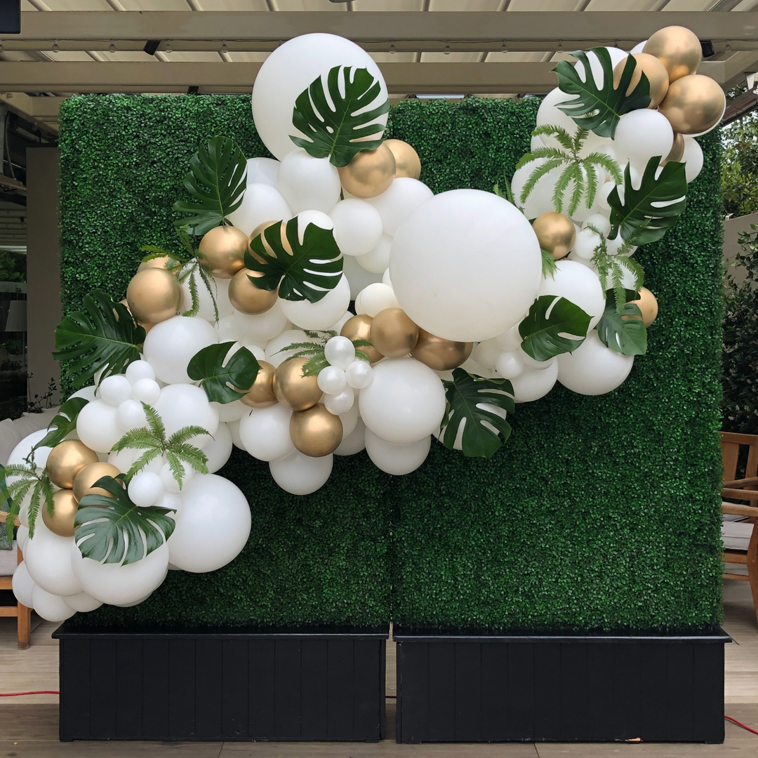White and gold balloon garland with tropical party decorations Tropical theme balloon decoration ideas - Los Angeles balloon installation