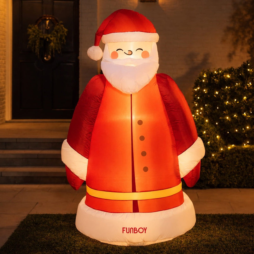 6 ft self-inflating vintage Santa lit up on a front lawn at night