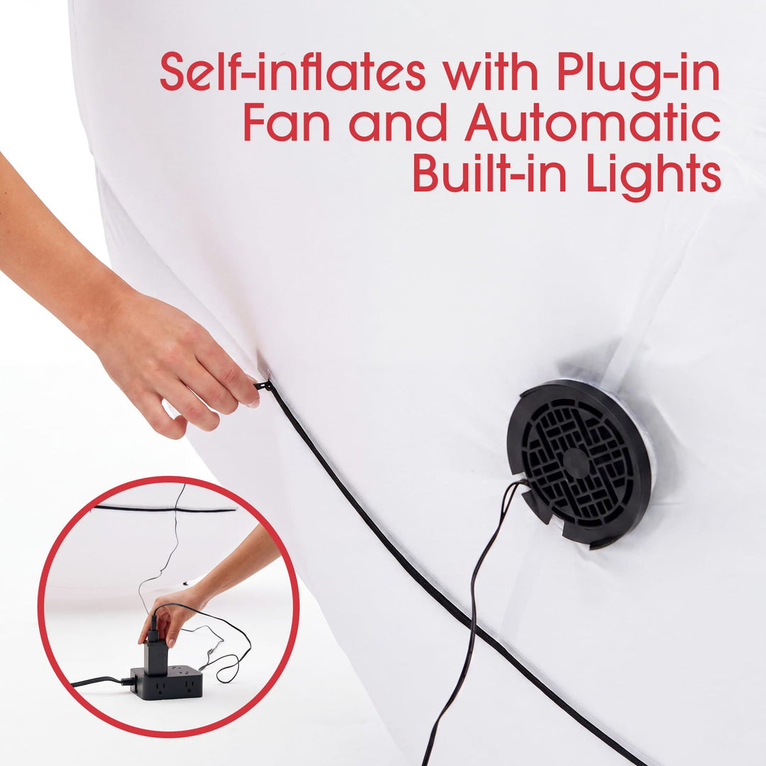Hand plugging in the built-in fan of the self-inflating Santa with lights