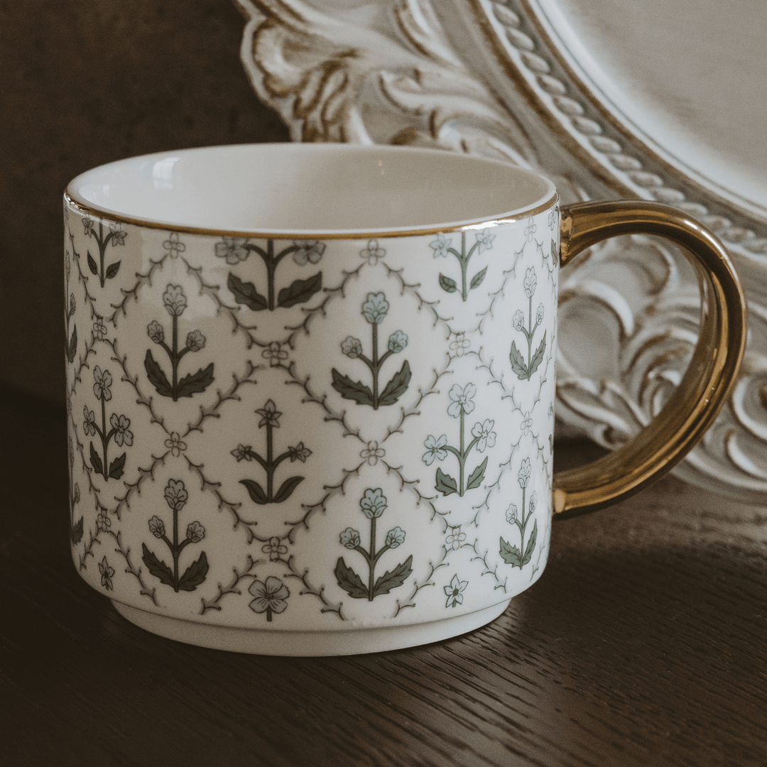 Close-up of the blue floral quilt design and real gold rim on the bone china mug