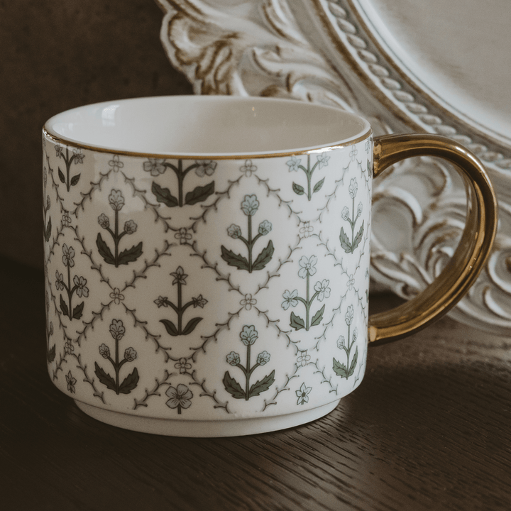 Close-up of the blue floral quilt design and real gold rim on the bone china mug