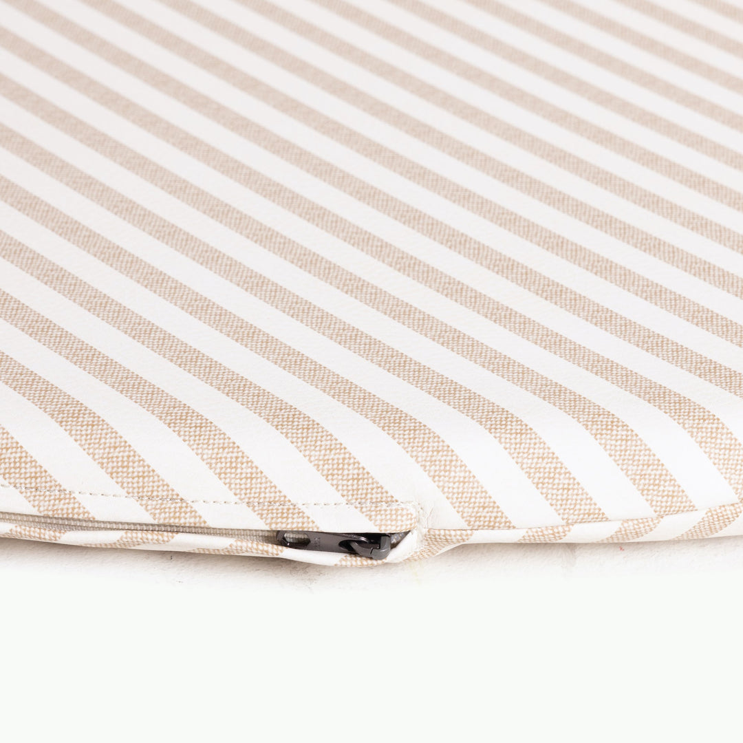 Close-up of the zippered edge on the cafe stripe padded play mat in tan and white