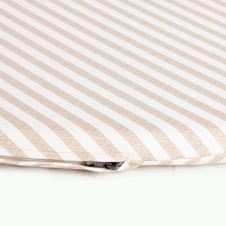 Close-up of the zippered edge on the cafe stripe padded play mat in tan and white