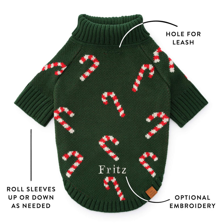 Callout of the green sweater back showing the leash hole, roll sleeves, and a sample embroidered name