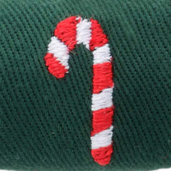 Macro of one red and white candy cane embroidered on green twill