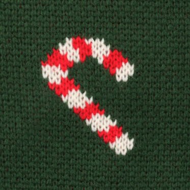 Knit close-up of one red and white candy cane on deep evergreen
