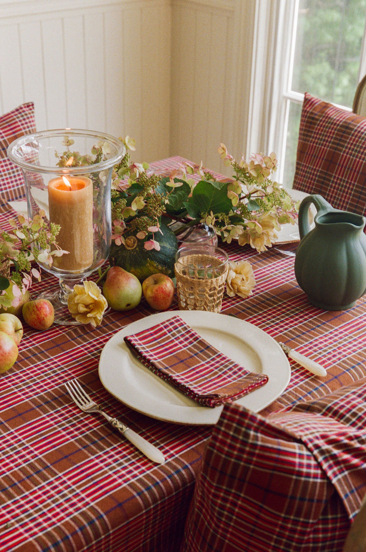 Holiday place setting on the Charlotte plaid tablecloth with a matching folded napkin