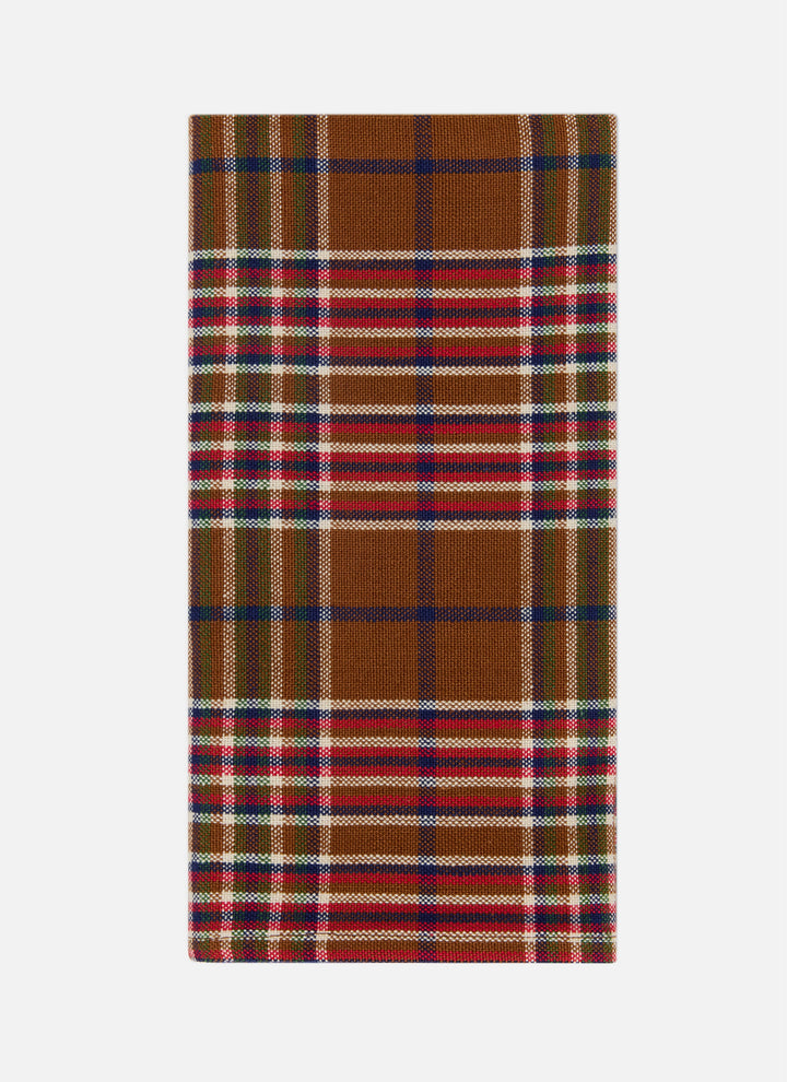 Charlotte plaid cloth napkin in nutmeg, red, indigo, and olive folded to show the weave